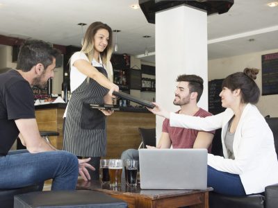 waitress-presenting-menu-female-customer-with-friends-bar